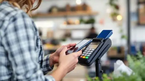 Australian shopper using smartphone contactless payment modern terminal
